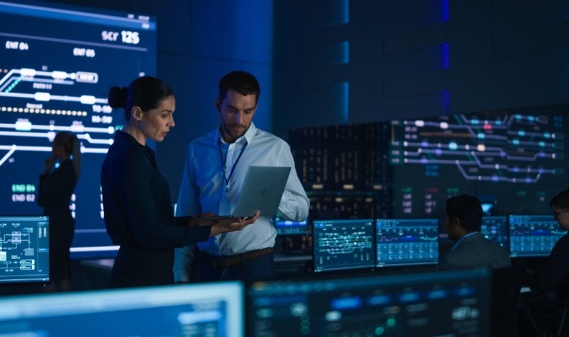 IT professionals reviewing systems in a network operations center